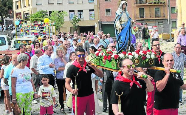Loa camareros celebran la procesión con la imagen de santa Marta en los alrededores de la iglesia de San Millán.
