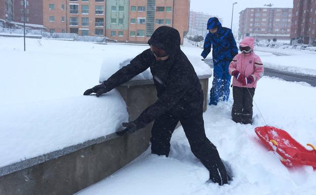Tres niños disfrutan con la nieve en Ávila./Ical