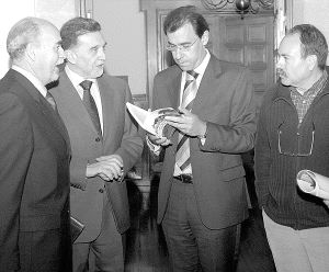 Martínez Maíllo ojea el libro en presencia de Miguel Alejo, a su lado, José Miranda y Luis González. / T. L./